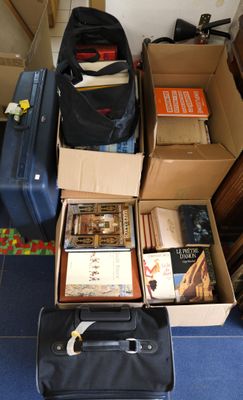 many suitcases and books on the floor in a room