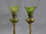 two green glass vases sitting on top of a table