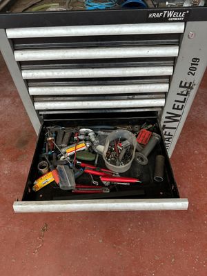 a tool box with tools in it sitting on the floor