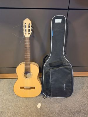 two guitars sitting next to each other on a carpeted floor