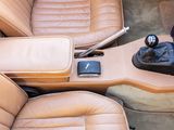 beige leather seats in a car with a cup holder and remote control