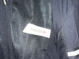 a label on the back of a black jacket