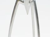 a stainless steel juicer that is on a white surface