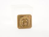 a small gold medal with a star on it