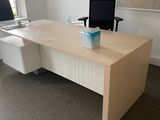 a desk with a computer and a monitor in a room