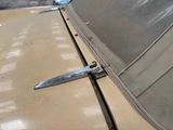 a knife stuck in the hood of an old car
