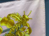 a picture of a yellow flower on a pink cloth