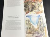 a book opened to show a picture of a city