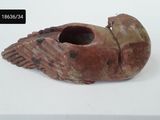 a small piece of pottery that is on a white surface