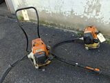 two electric tools that are sitting on the ground