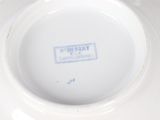 a white plate that has a blue and white label on it