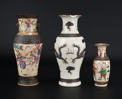 three vases with different designs on them on a black surface