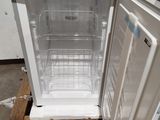 a white refrigerator with a door open on a pallet