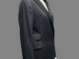 a mannequin wearing a black suit with a white shirt and black pants