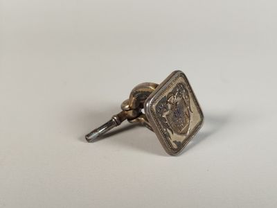 an image of a small metal object on a white surface