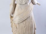 an image of a statue of a woman holding a bird
