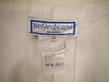 the label of a white dress with a blue and white design on it