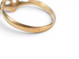 a close up of a gold ring on a white surface
