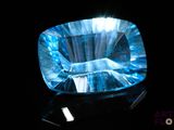 an image of a blue topazte stone on a black surface
