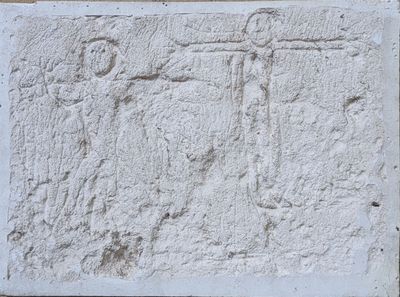 an image of a stone relief of a man holding a sword and a woman holding a sword