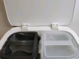 a small white refrigerator with two plastic containers inside of it