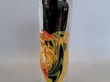 a glass vase with a painting on it on a table