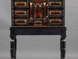 a black and gold painted desk with drawers and drawers