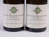 two bottles of wine sitting next to each other on a white surface