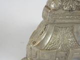 a silver statue that is sitting on a white surface