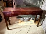 a wooden table with three drawers on top of it