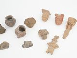 several pieces of pottery sitting on top of a white surface