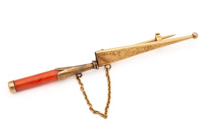 an image of a gold and red pen with a chain on a white background