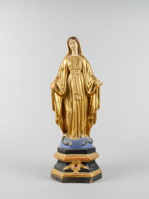 a gold statue of the virgin of guadalupe on a pedestal