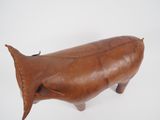 brown leather whale sculpture on white surface with white background