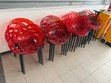 several red chairs lined up against a wall in a room