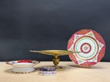 a plate and a bowl on a table with a black background