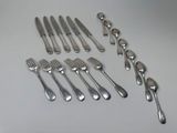 a lot of forks and spoons that are on the table