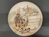 a plate with a picture of a man and a dog on it