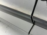 a close up of a car door handle and a window