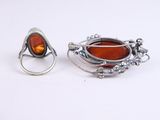 pair of silver and amber rings and a ring with a tear shaped stone