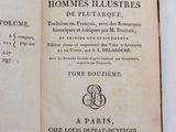 an open book on a white table with french writing on it