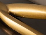 a close up view of a gold sculpture of a banana