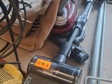 a vacuum that is sitting on the floor next to a bag