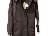 an image of a coat hanging on a hanger on a wall