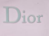 a sign that says dior on the side of a building
