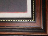 a close up of a picture of a painting on a wall