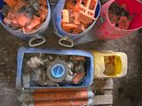 several buckets filled with orange and blue items sitting on top of a wooden pallet