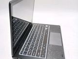a black laptop with a silver keyboard on a white surface