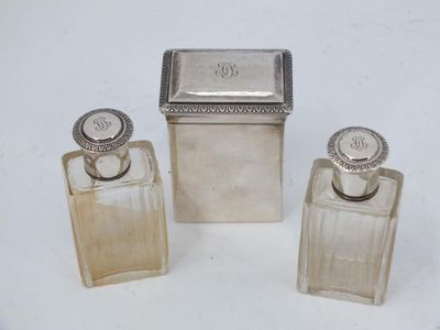 three small silverplated perfume bottles and a small silverplated box
