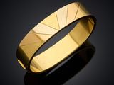 a close up of a gold ring on a black surface